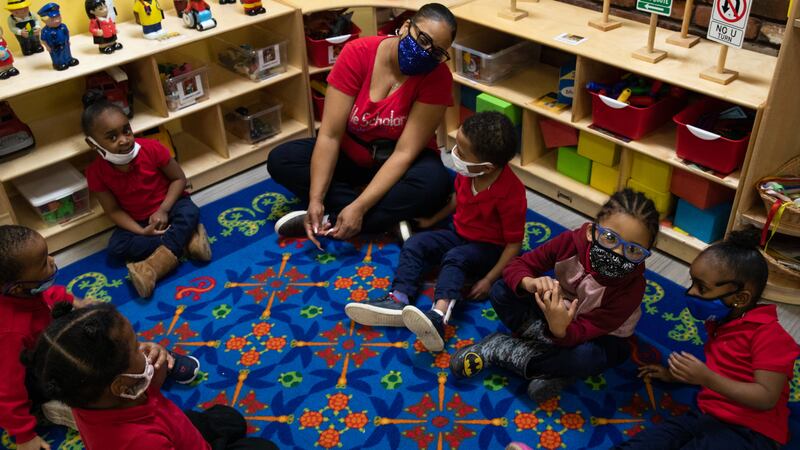 Preschoolers sit in a circle as they participate in morning exercises at Little Scholars child care center in Detroit, Michigan, U.S., on Thursday April 1, 2021.