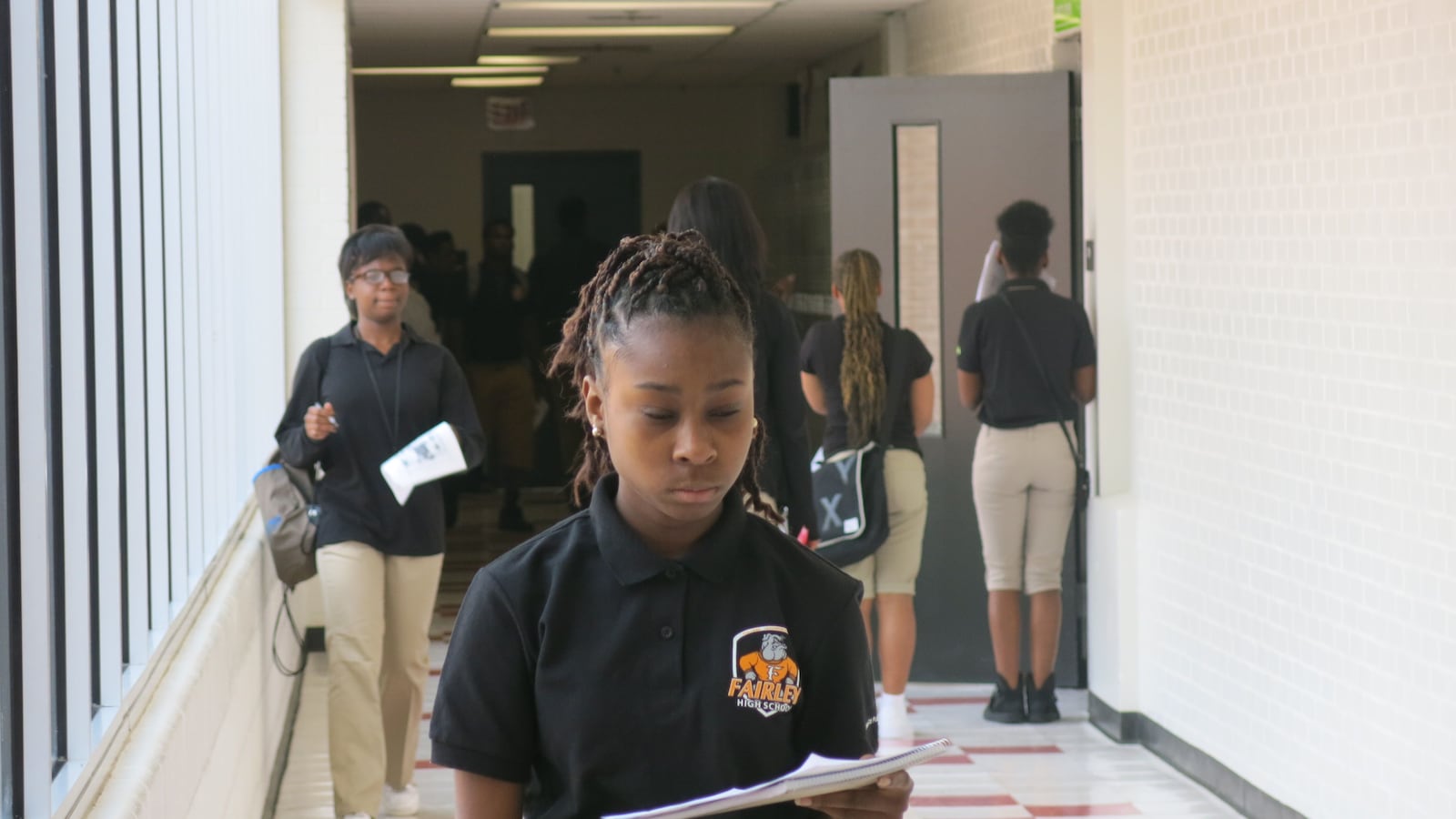 Students check their schedules during a transition at Fairley High School.