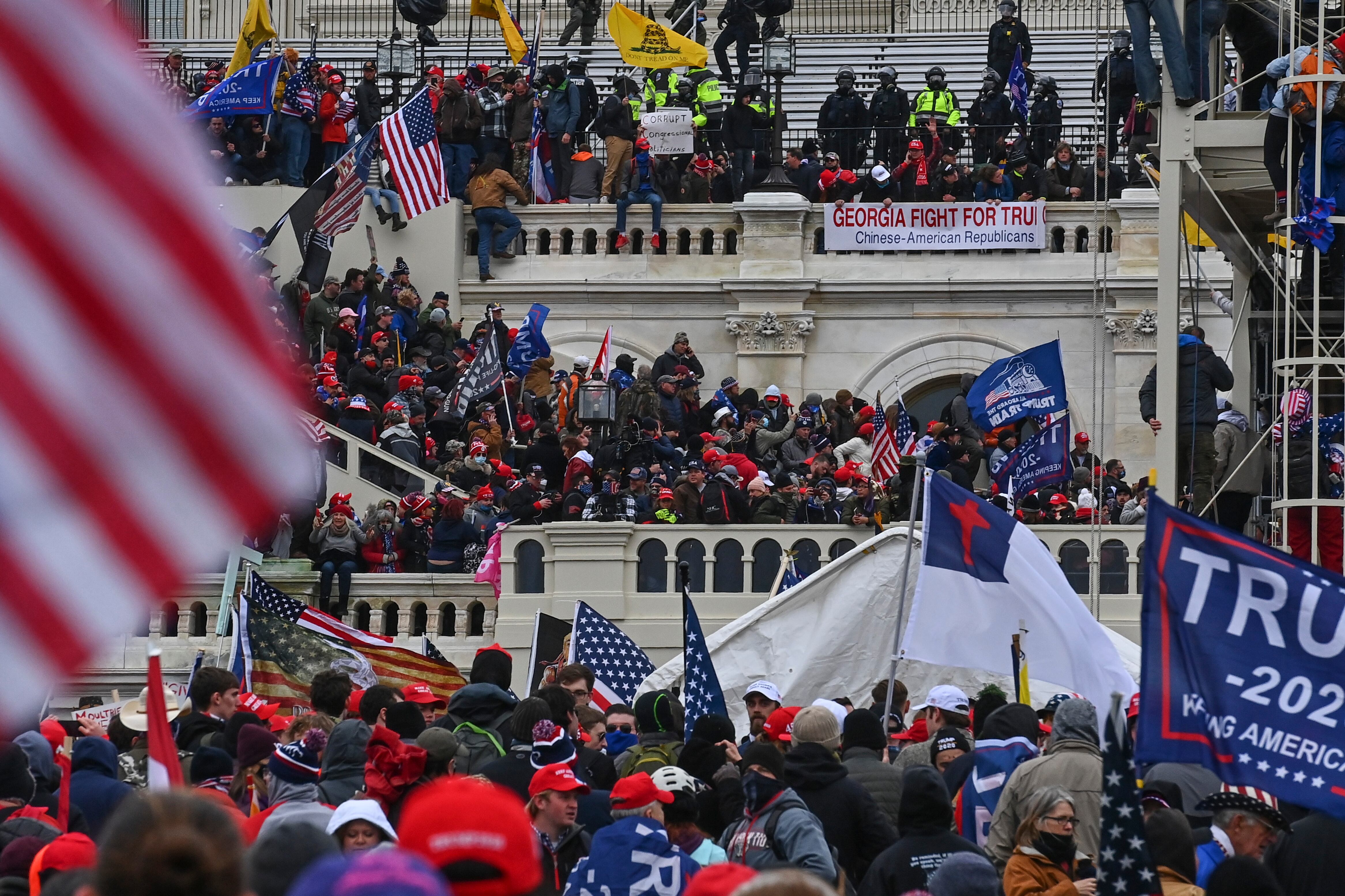 Scores of supporters of Donald Trump scale the walls of the U.S. Capitol during the January 6th Capitol Riot.