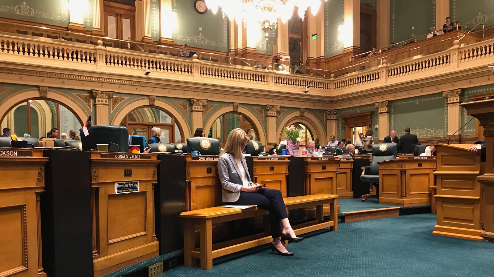 State Rep. Brittany Pettersen, a Lakewood Democrat, sits alone on the House of Representatives floor as members of her own party filibustered her compromise on charter school funding. (Photo by Nic Garcia)