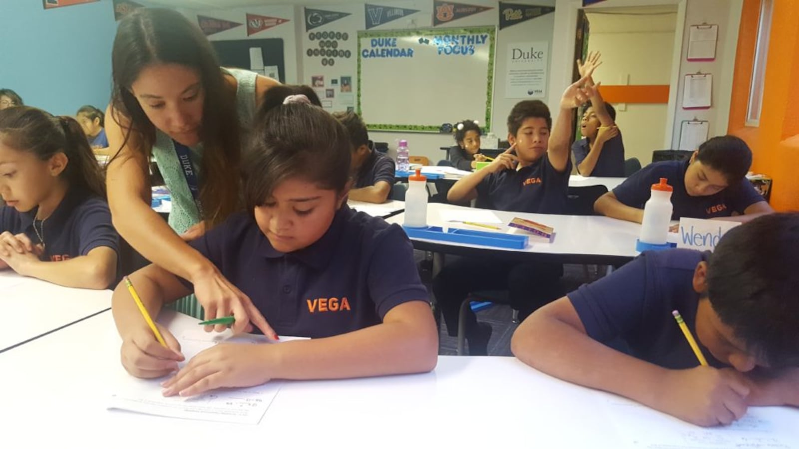 Teacher Gabrielle Mahon works with sixth-graders during a math lesson in September 2018 at Vega Collegiate Academy in Aurora.