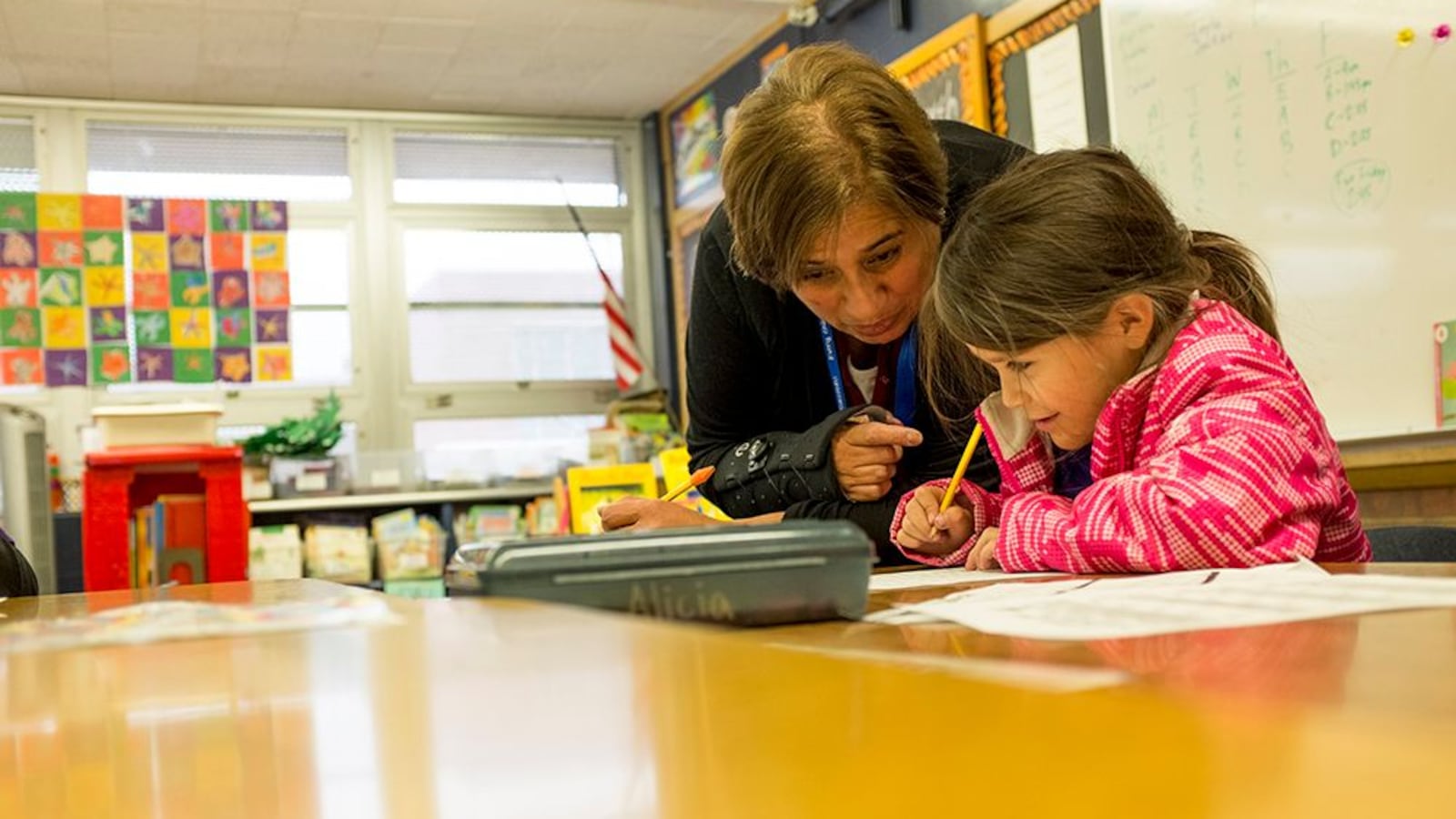 Paraprofessional Bertha Finney works with a first-grade student on a writing assignment at Denver's Goldrick Elementary School in 2017.