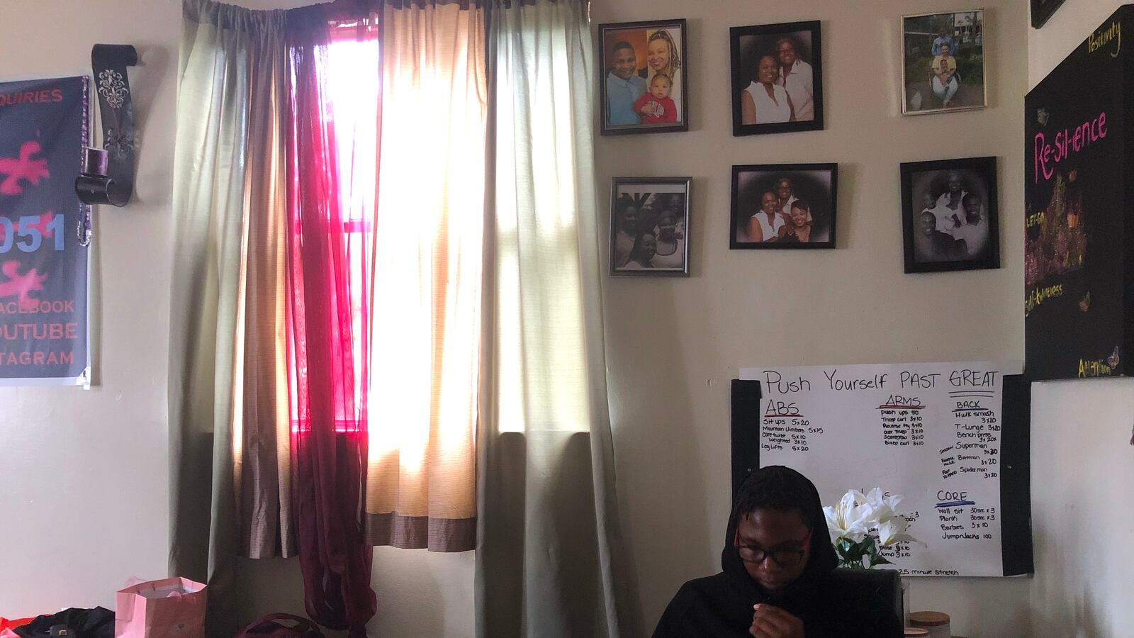 Jalan sitting in his learning space with his laptop.