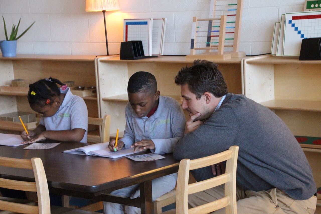 Bob Nardo, right, works with a Libertas student.