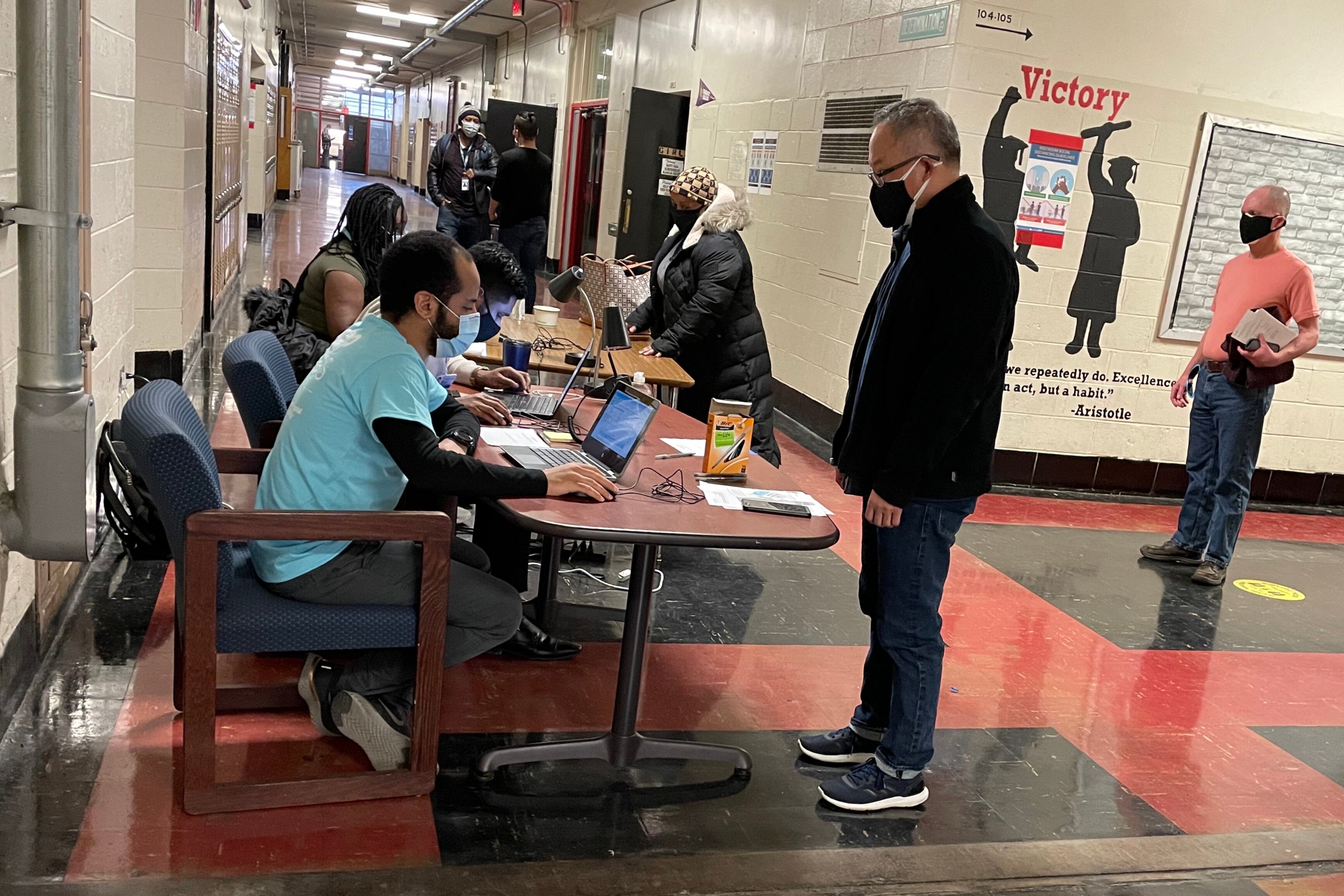 Philadelphia teachers wait to check out after getting vaccinated at South Philadelphia High School Thursday.