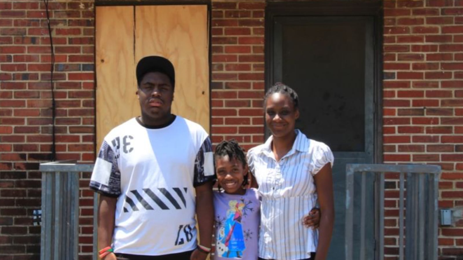 Tiara Edmond (right) and her children Jamal, 16, and Joemaya, 9, stand outside their apartment in the Foote Homes housing project.