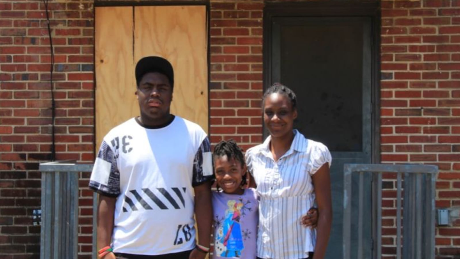 Tiara Edmond (right) and her children Jamal, 16, and Joemaya, 9, stand outside their apartment in the Foote Homes housing project.