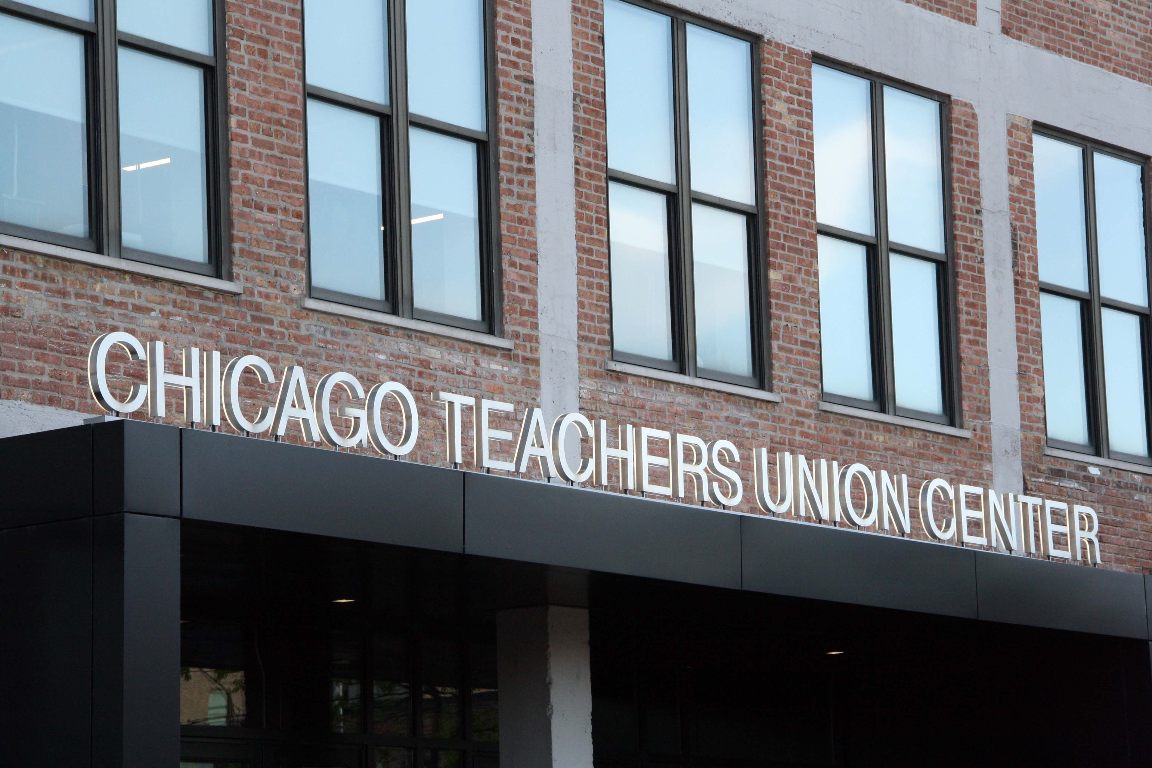 A Chicago Teachers Union sign hangs on a building.