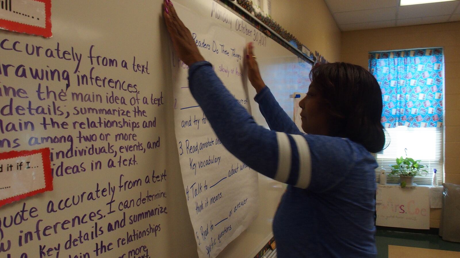Carolyn Coe prepares her fifth-grade classroom at Winridge Elementary School for the introduction of a new curriculum in English language arts.  Expeditionary Learning is aligned with more Common Core learning standards and will offer students more complex texts to read and understand.