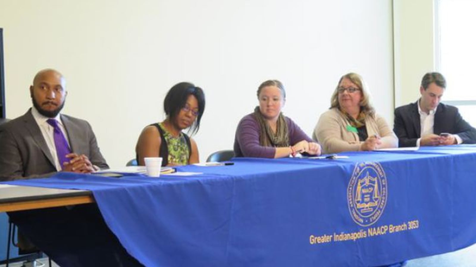 Indianapolis Public School Board candidates David Hampton, Samantha Adair-White, Annie Roof, Kelly Bentley and Josh Owens sit at a candidate forum hosted by the Greater Indianapolis NAACP chapter last month.