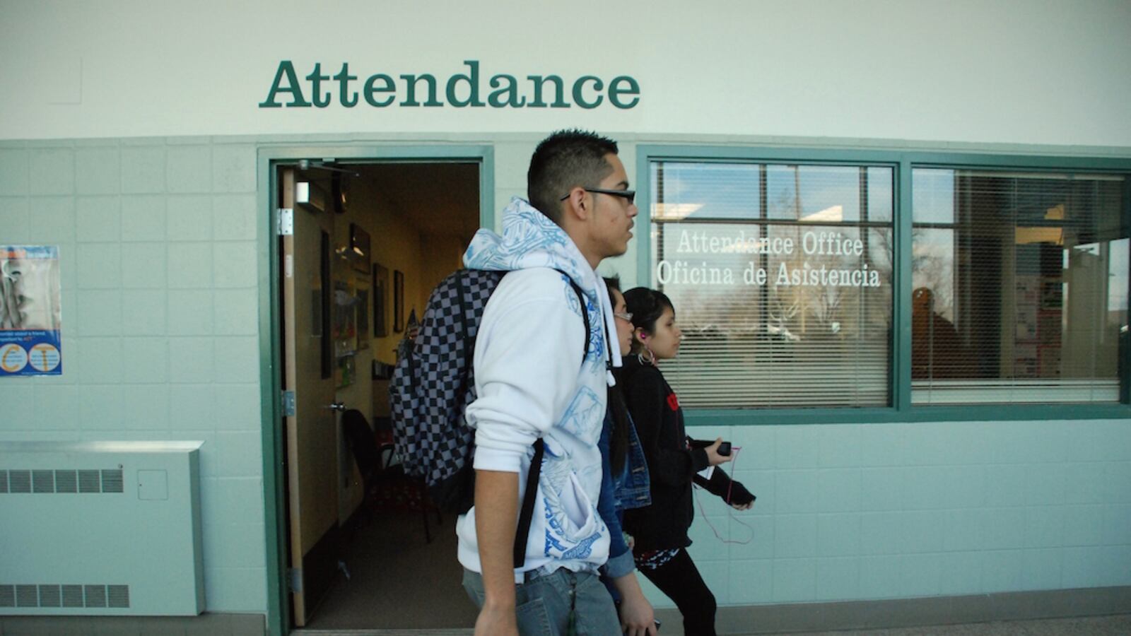 Aurora Central High School students walk past the attendance office.