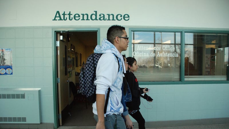 Aurora Central High School students walk past the attendance office.