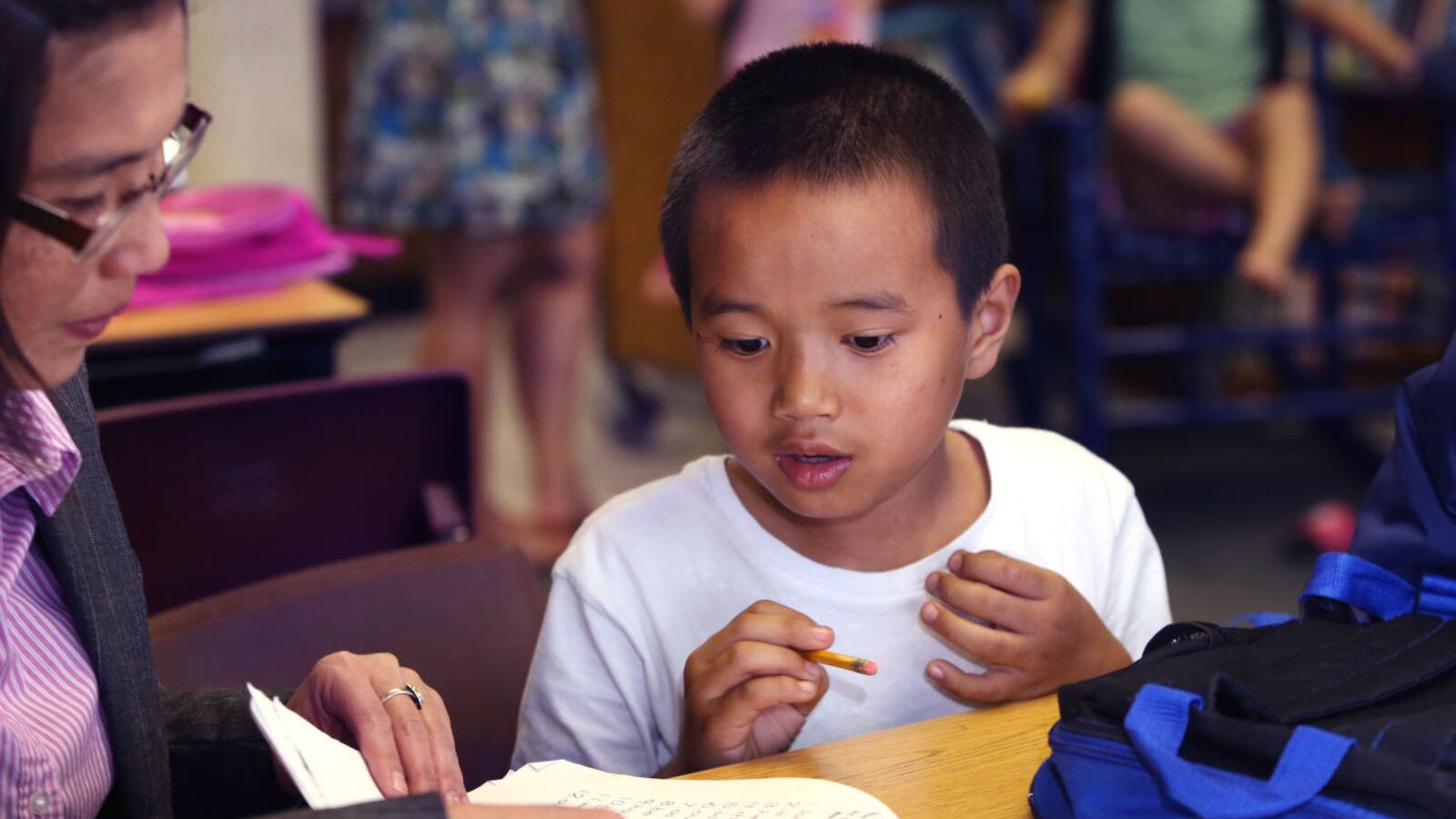 May Oo Mutraw, president of the Burmese Community Center for Education, works on spelling with six-year-old Ngae Reh in 2015.