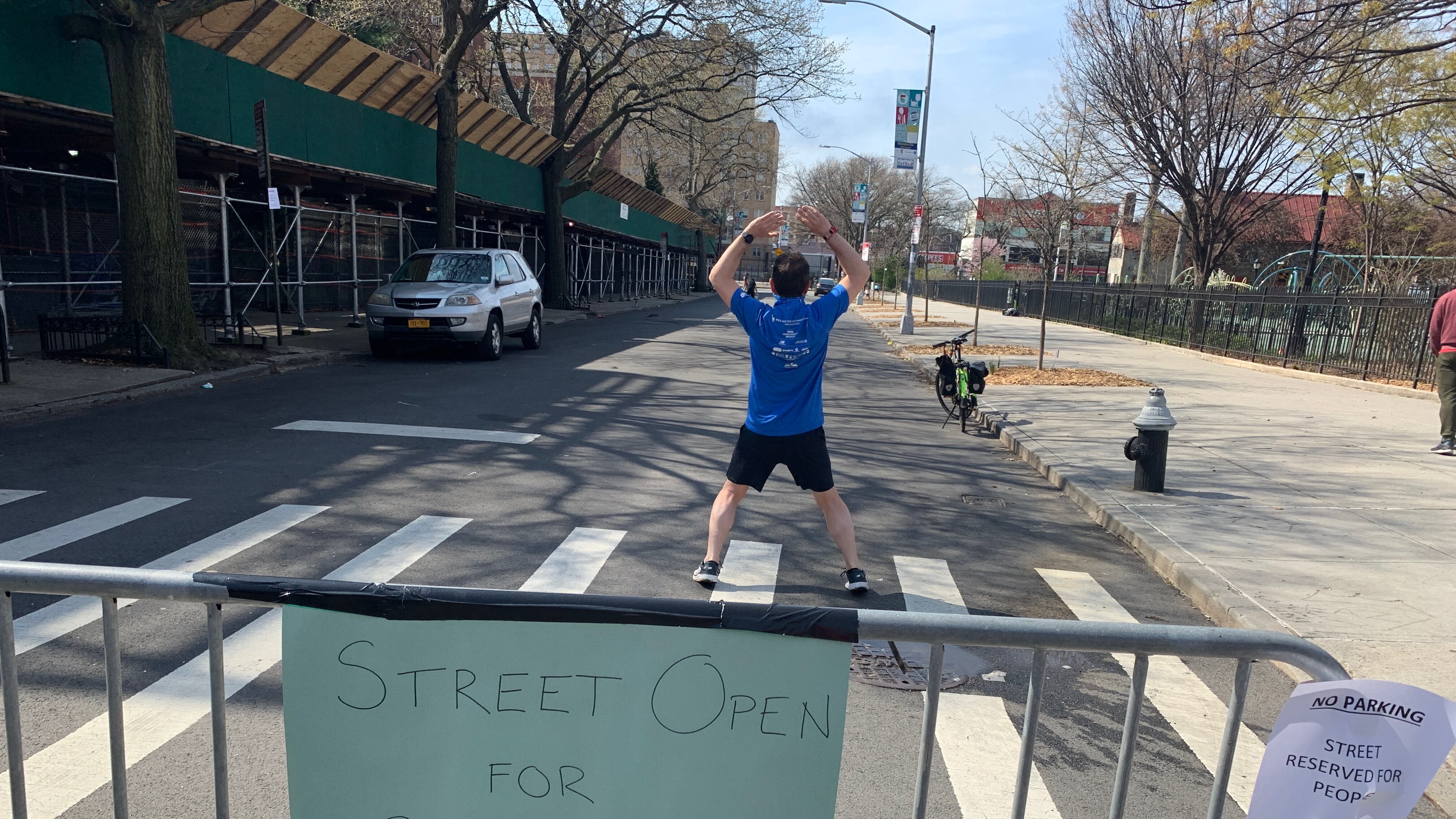 A person exercises on a NYC street closed to traffic. 