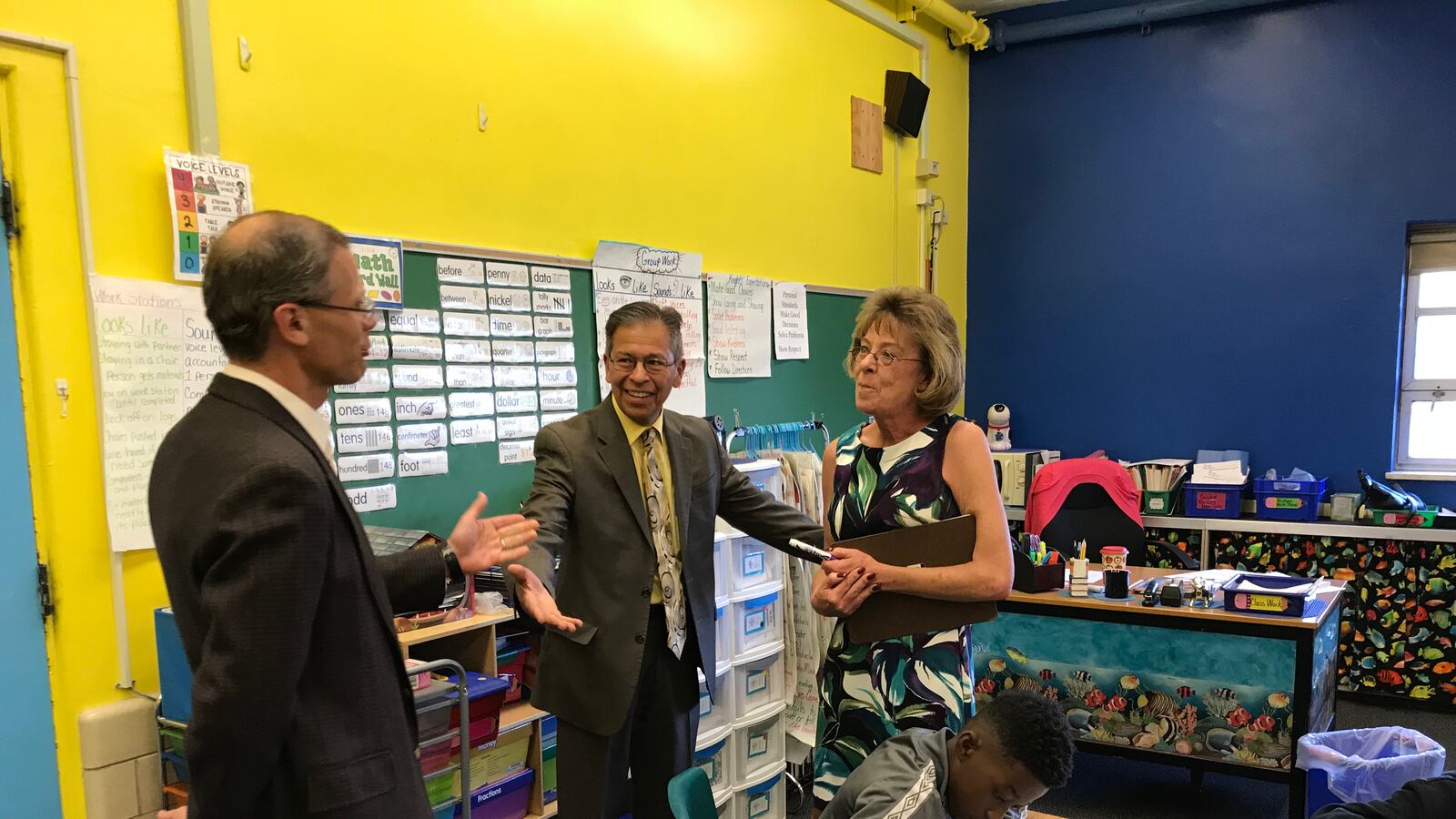 Denver Superintendent Tom Boasberg tells Stedman Elementary teacher Dawn Romero that her former principal, Ron Cabrera, center, is the new interim superintendent.