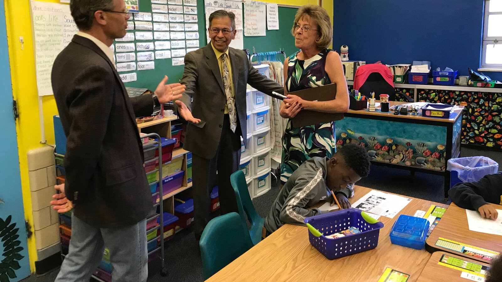 Denver Superintendent Tom Boasberg tells Stedman Elementary teacher Dawn Romero that her former principal, Ron Cabrera, center, is the new interim superintendent.