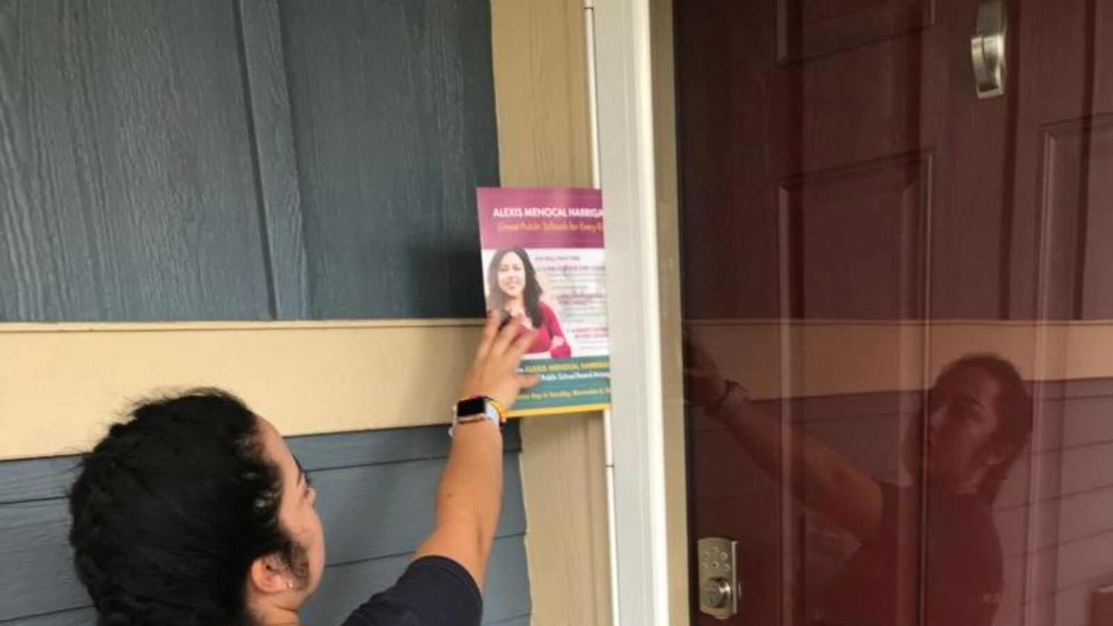 College student and SFER canvasser Emma Menchaca-Chavez leaves a flyer on a door.