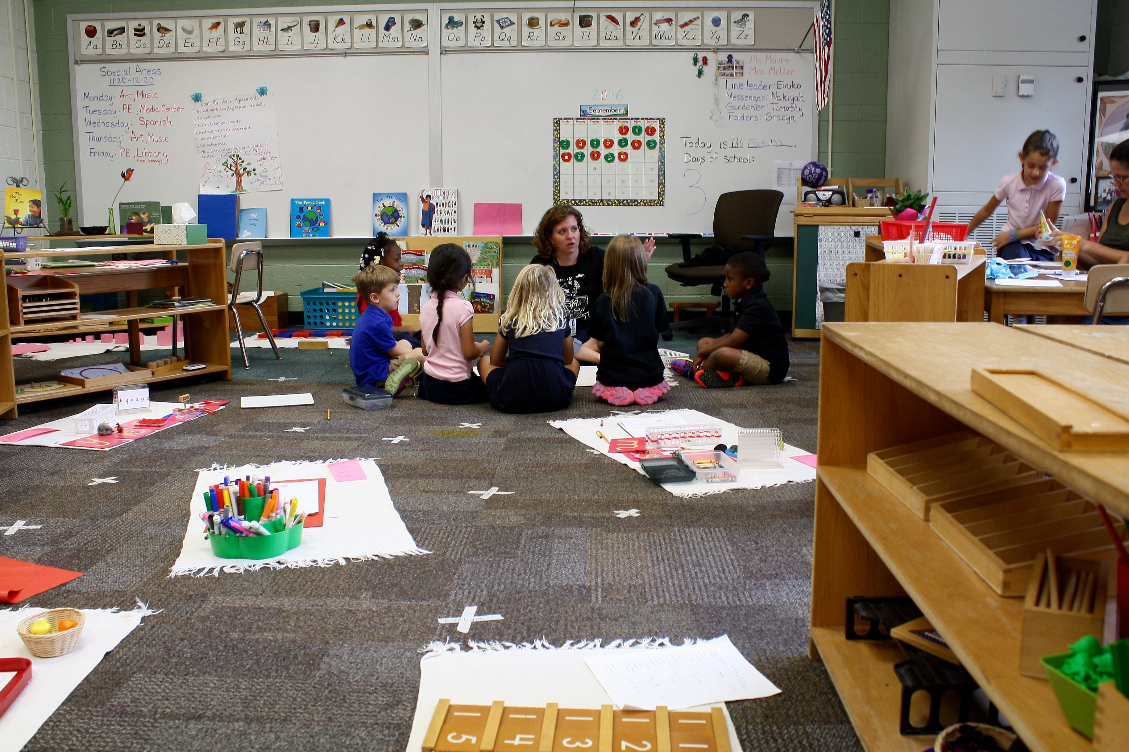 Preschool and kindergarten students at IPS School 91 work in a small group with their teacher. The school is one of the district’s high-performing integrated Montessori magnets that is attracting families from outside district boundaries.