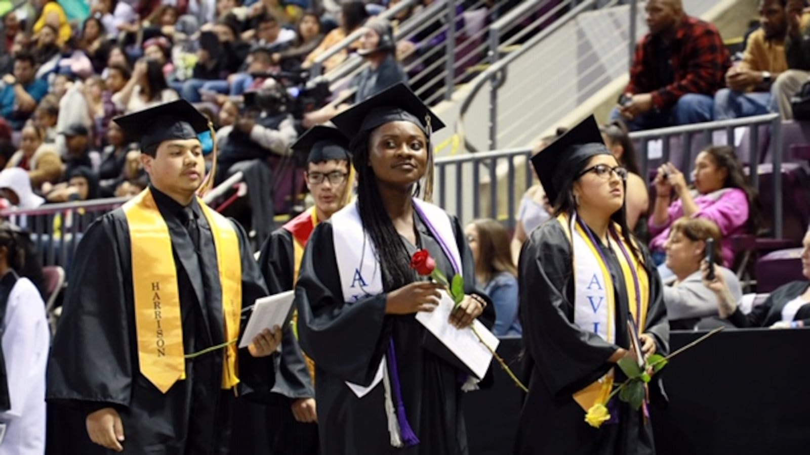 Avid students at Harrison High School's 2019 graduation ceremony stand proudly after receiving their diplomas.