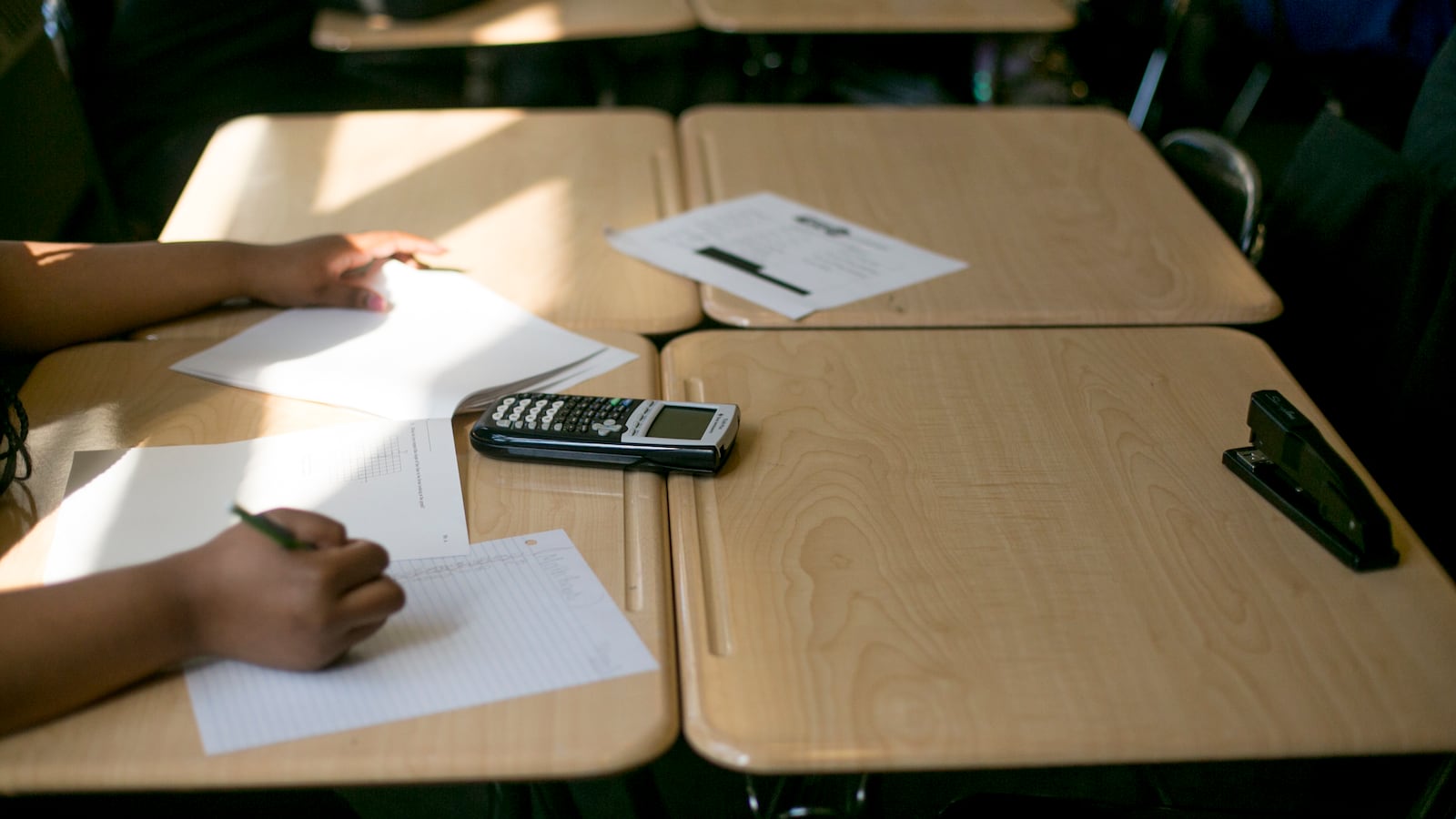 A calculator sits on a desk as students work in a math class at Southeastern High School in Detroit, MI. Photo by Anthony Lanzilote/Chalkbeat �June, 2019 photo�