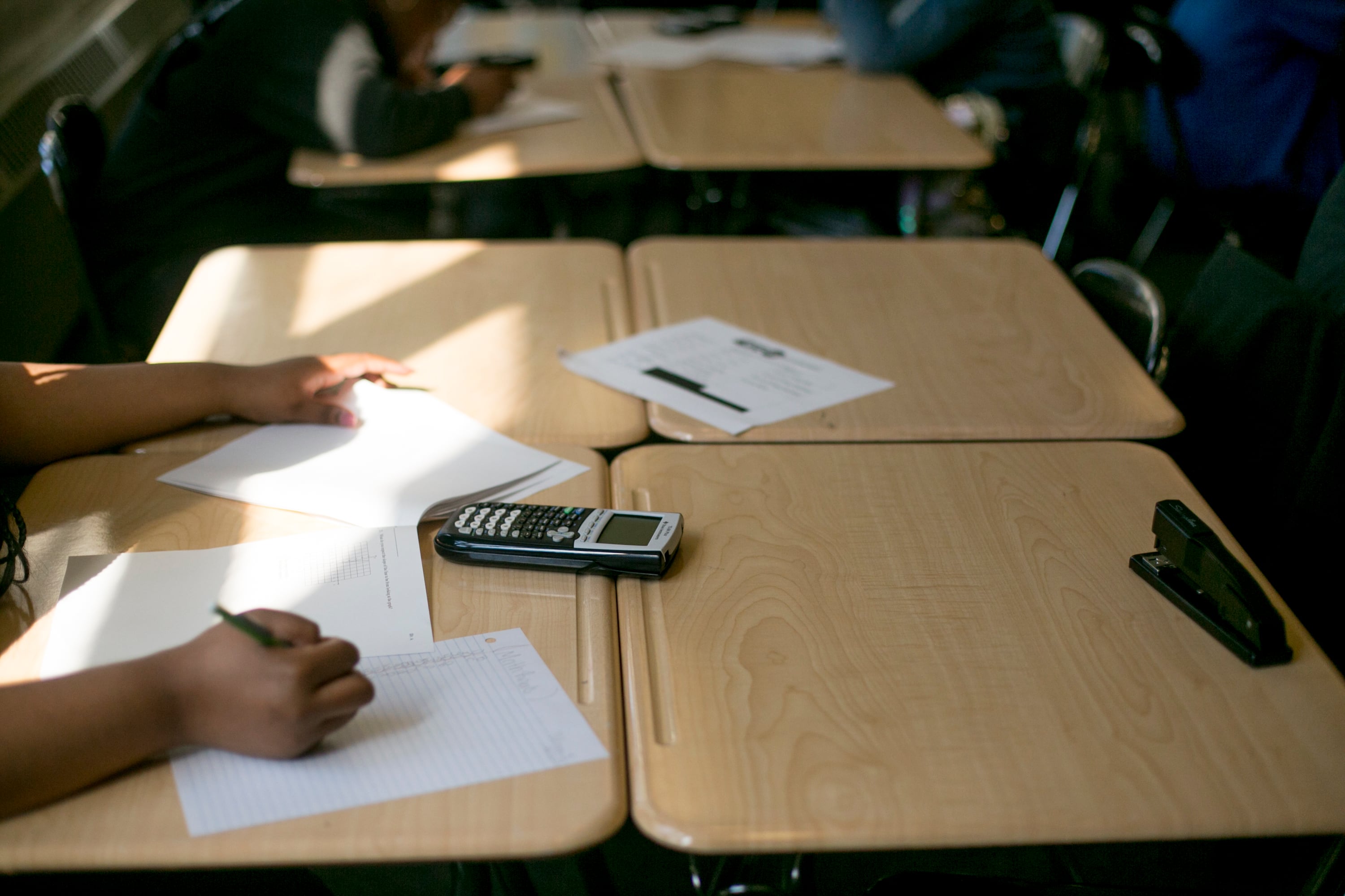 A calculator sits on a desk as students work in a math class at Southeastern High School in Detroit, MI. Photo by Anthony Lanzilote/Chalkbeat �June, 2019 photo�