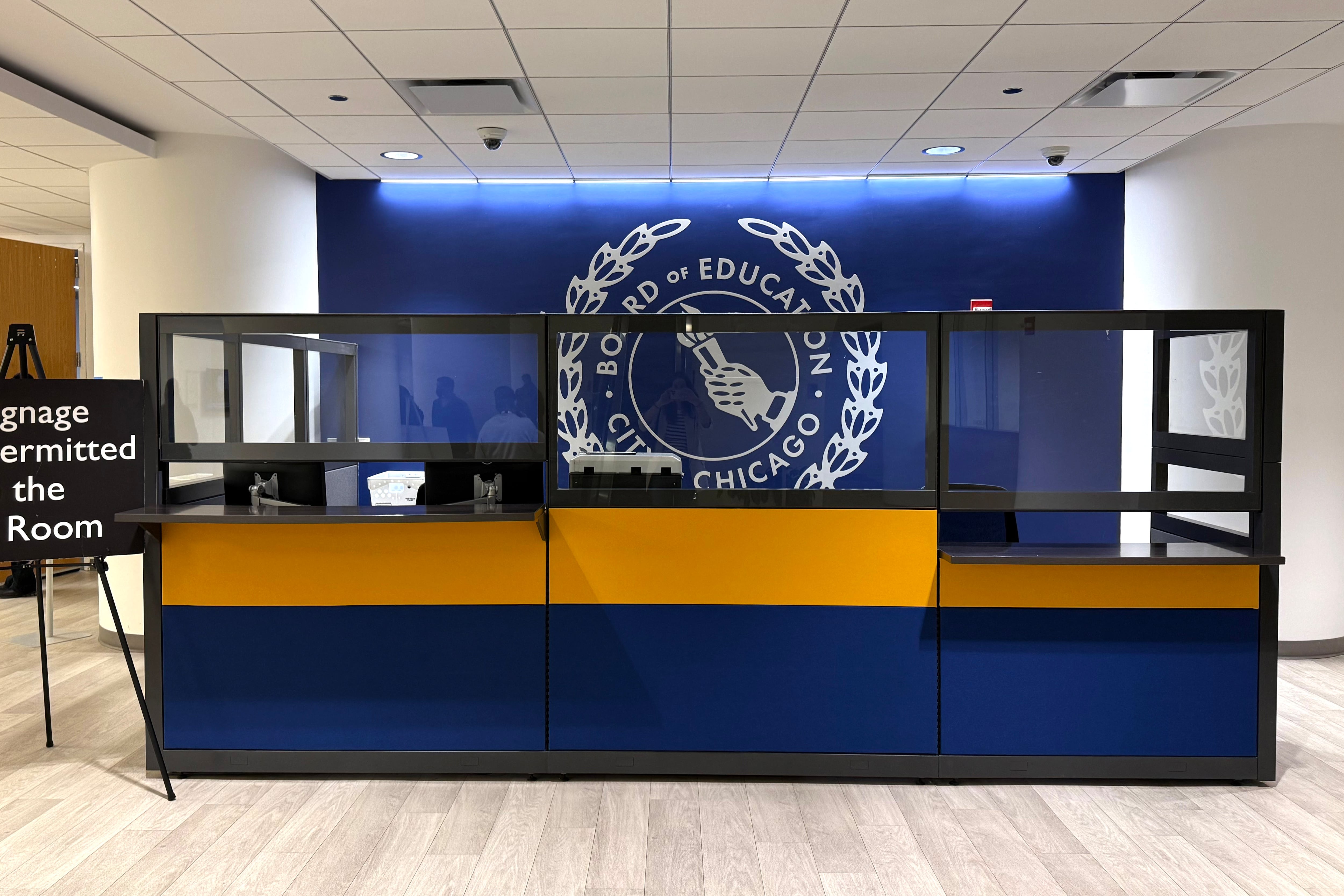 A photograph of an empty desk with a blue background.
