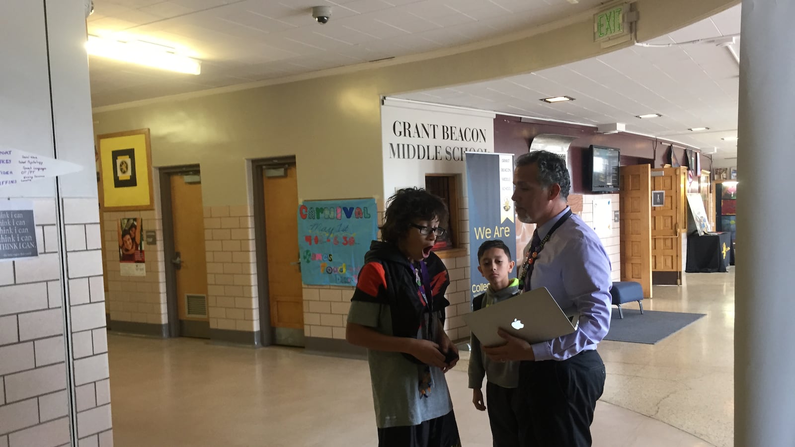 Alex Magaña, then principal at Grant Beacon Middle School, greeted students as they moved between classes in 2015.