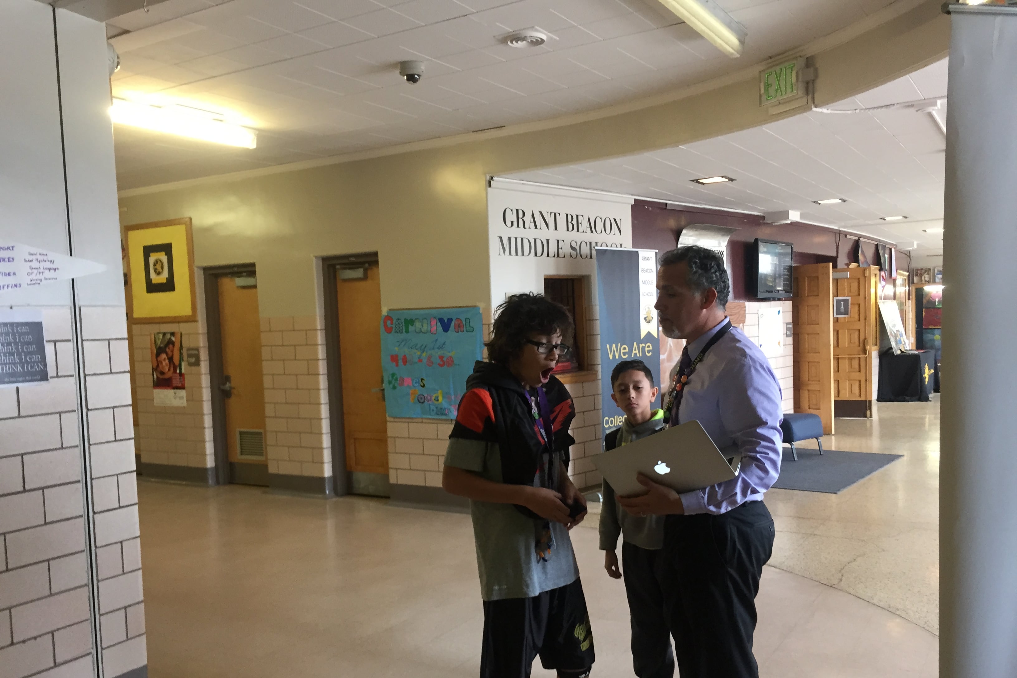 Alex Magaña, then principal at Grant Beacon Middle School, greeted students as they moved between classes in 2015.