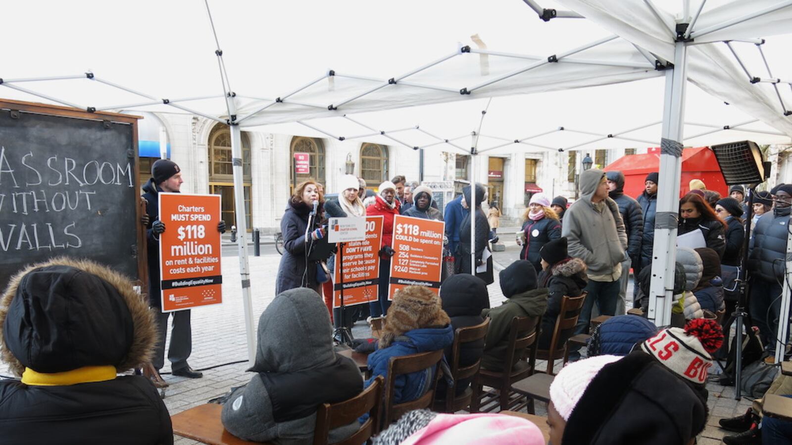 Vasthi Acosta, principal of Amber Charter School, speaks to students at an event meant to highlight funding disparities facing charter schools in private space.