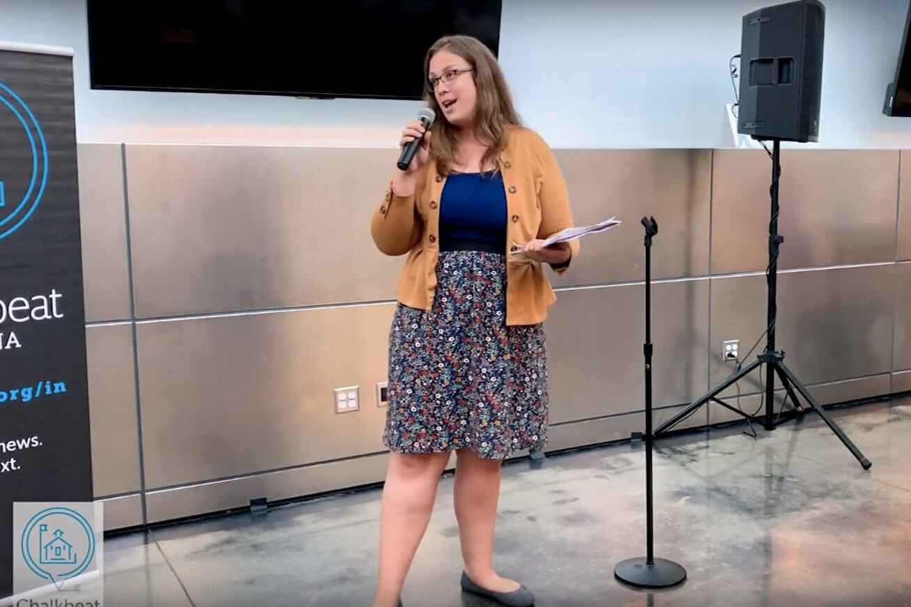 woman holds microphone and talks