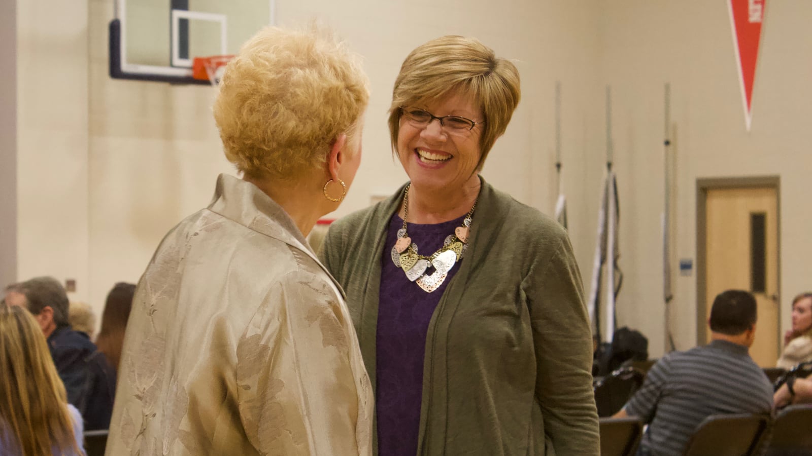 Pam Mazanec, right, greets former state board member Debora Scheffel at a Douglas County school board forum in November 2017. (Photo by Nic Garcia)