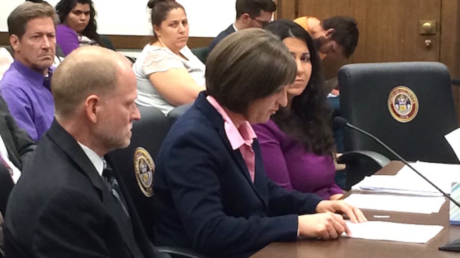 Desiree Davis (center) testifies at the Capitol while husband Michael (left) listens.