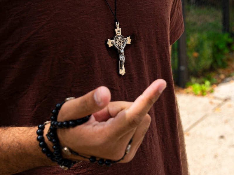 A cross necklace and a rosary