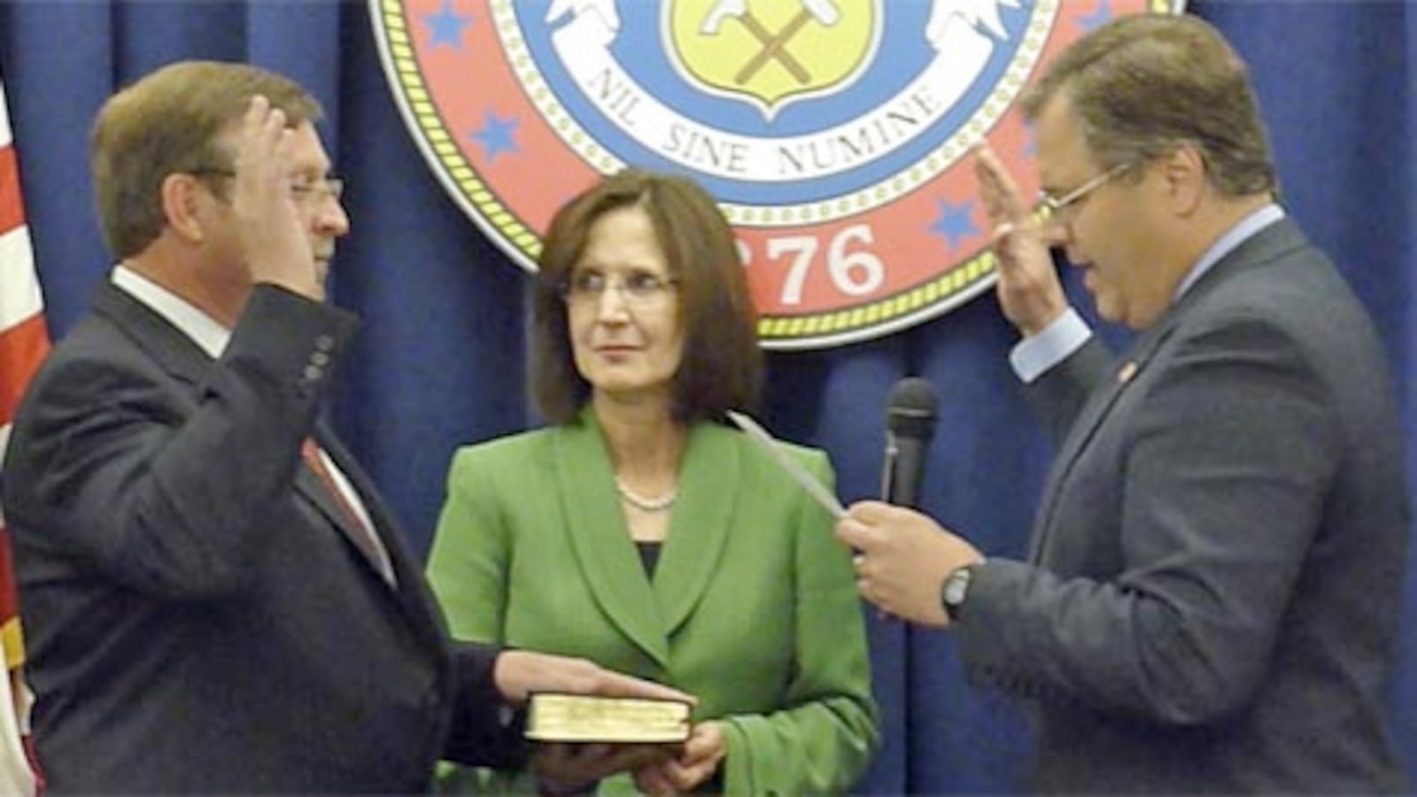 Education Commissioner Robert Hammond (left) took the oath of office May 11, 2011, from SBE Chair Bob Schaffer. Hammond's wife, Ranelle Lang, holds the Bible. She's former superintendent in Greeley.
