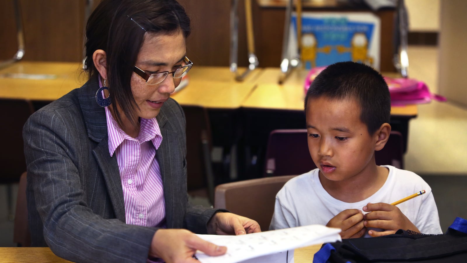 May Oo Mutraw, president of the Burmese Community Center for Education, works on spelling with Ngae Reh, 6, at the BCCE after-school learning time at Nora Elementary School in Indianapolis.