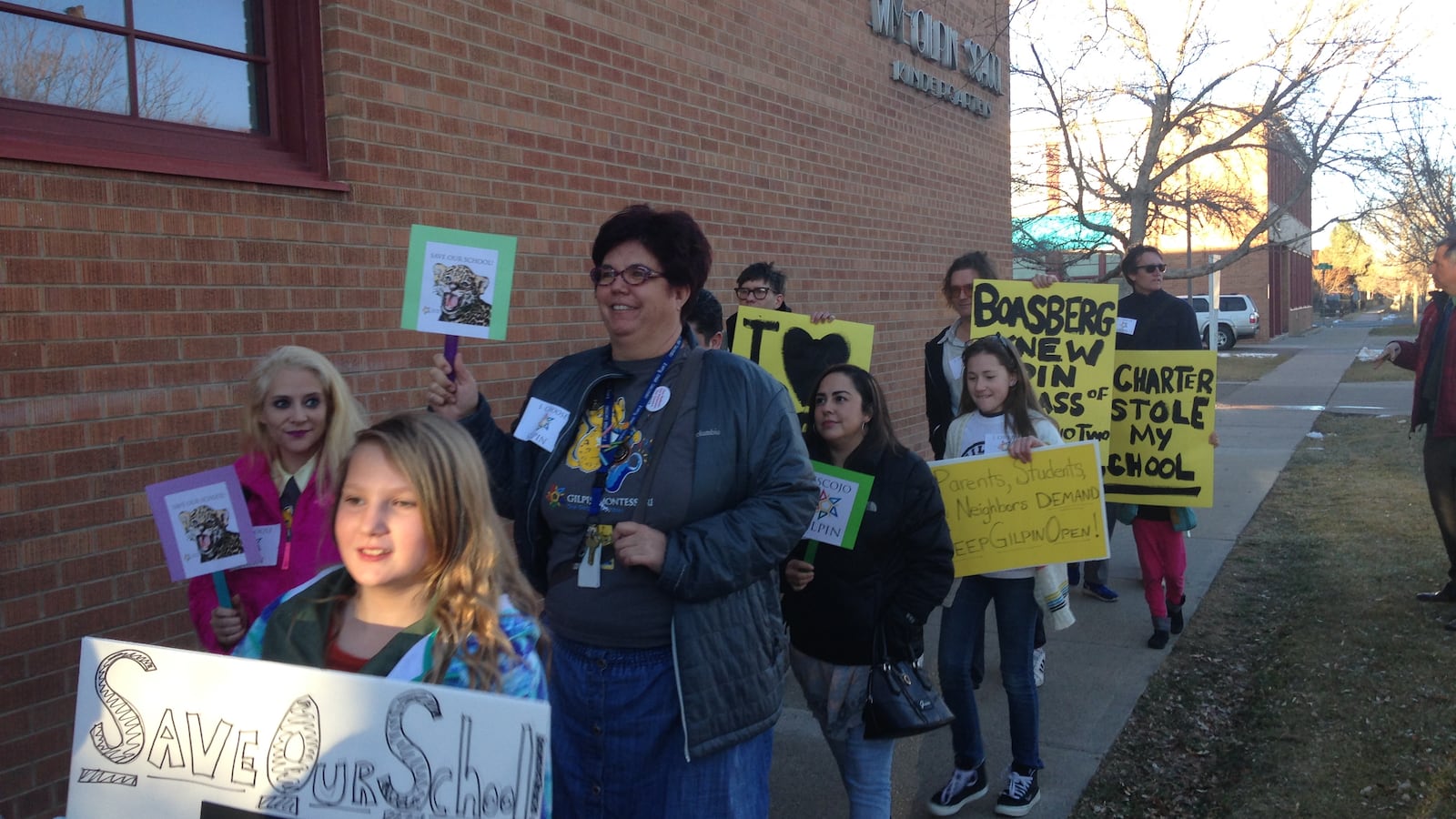 Supporters of Gilpin Montessori School march to a school board meeting Thursday.