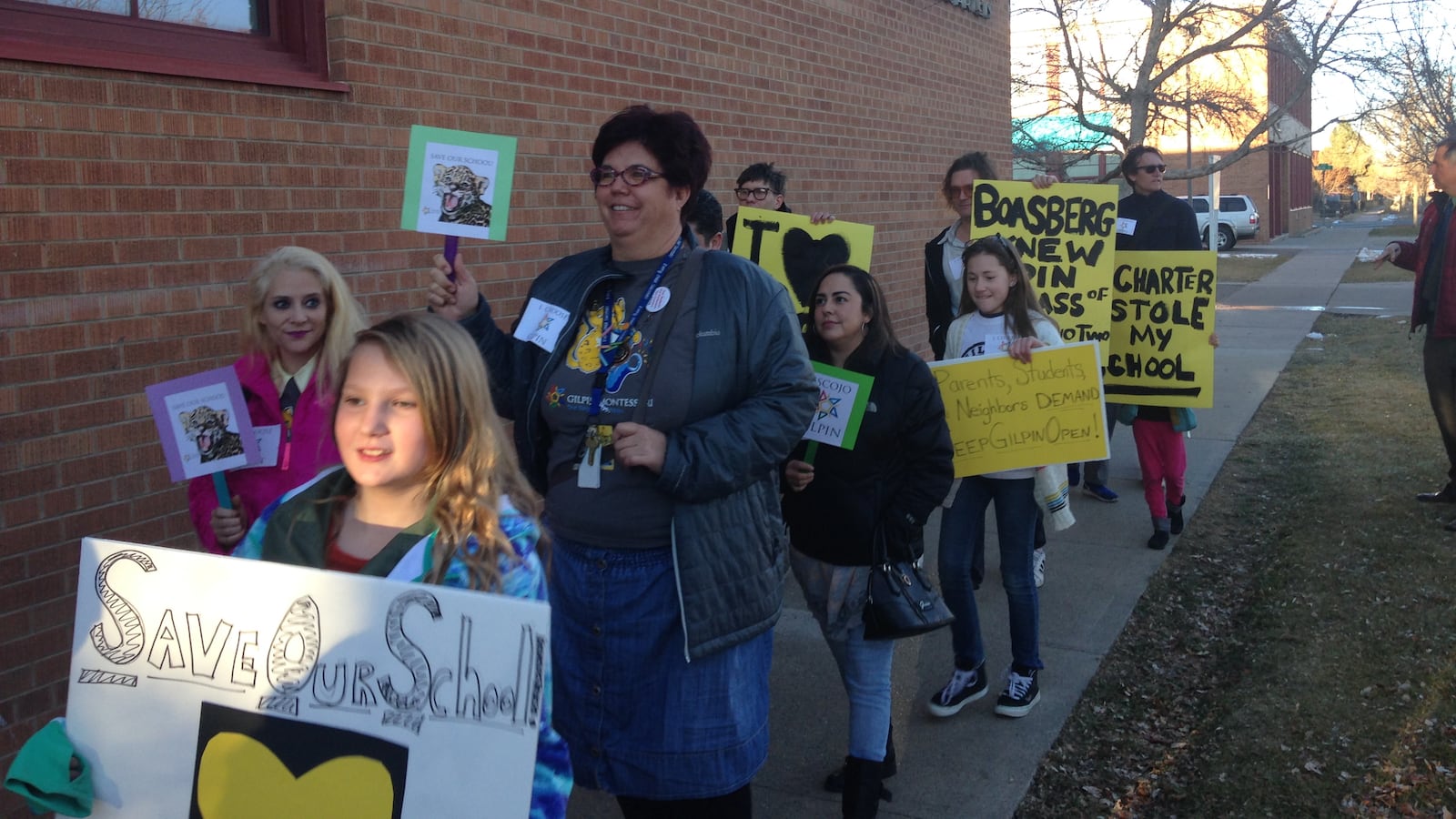 Supporters of Gilpin Montessori School march to a school board meeting Thursday.
