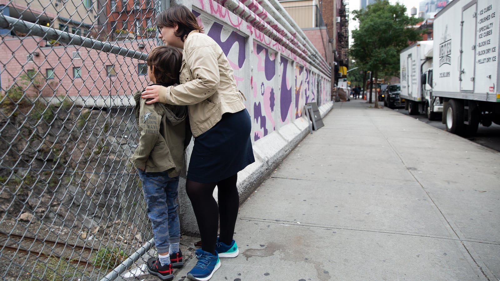 Eliyanna Kaiser and her seven-year-old son, who has autism, watch for Amtrak trains near their Hell’s Kitchen home, Oct. 14, 2019.
