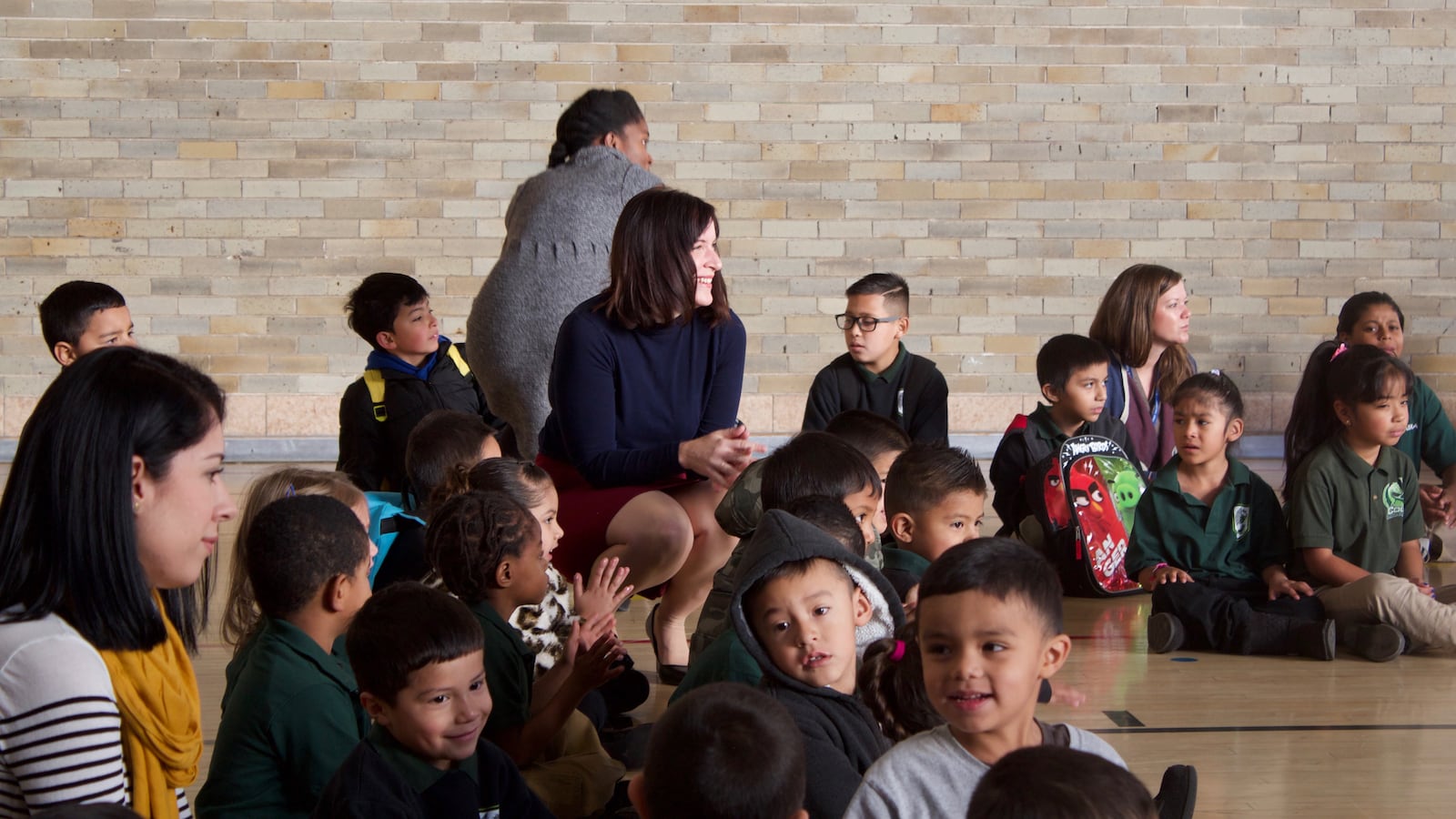 CASA Principal Jennifer Jackson sits with students at a school meeting in November 2015.
