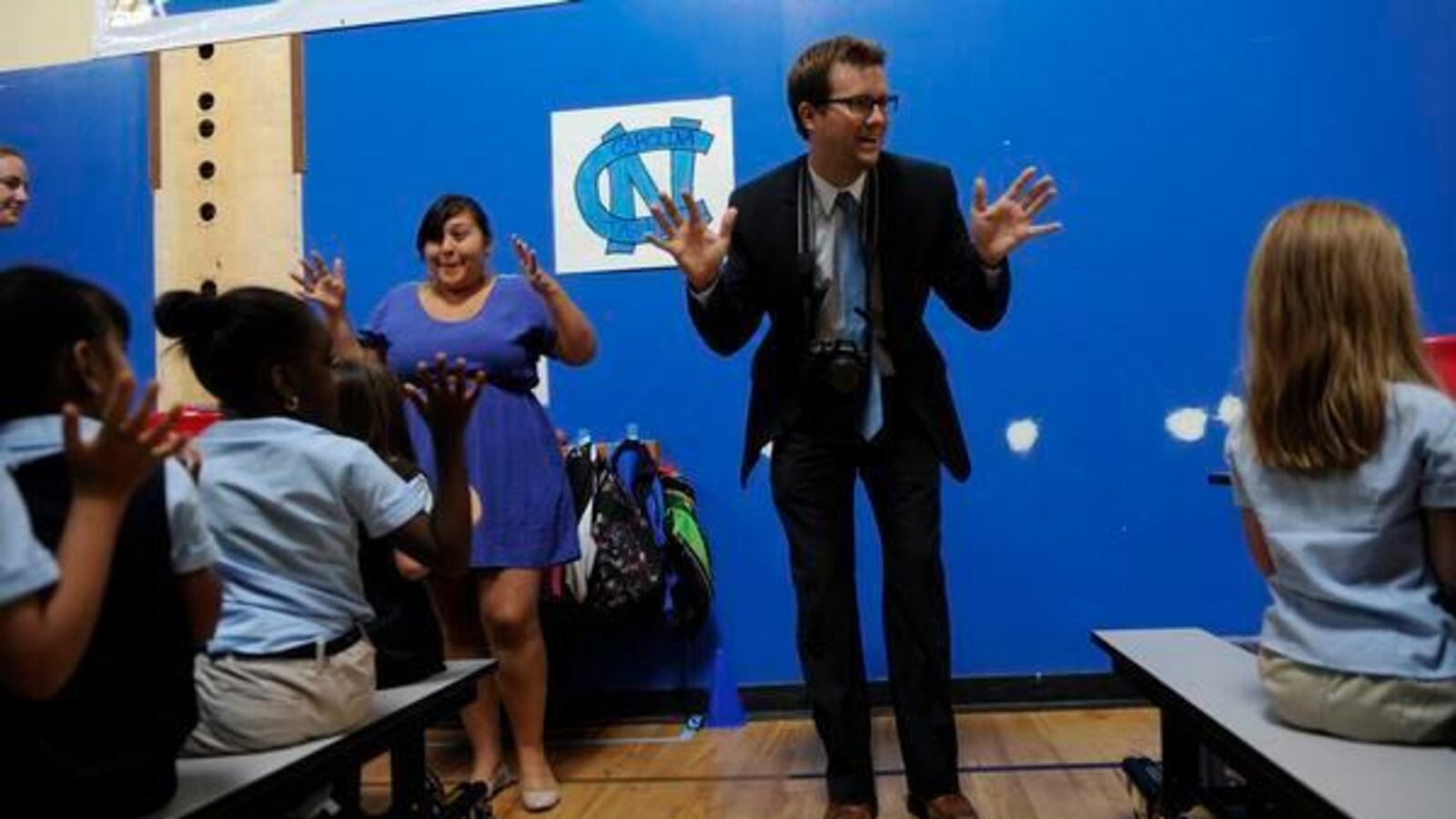 James Cryan, founder of Rocky Mountain Prep, leads students and staff in a cheer in 2012.