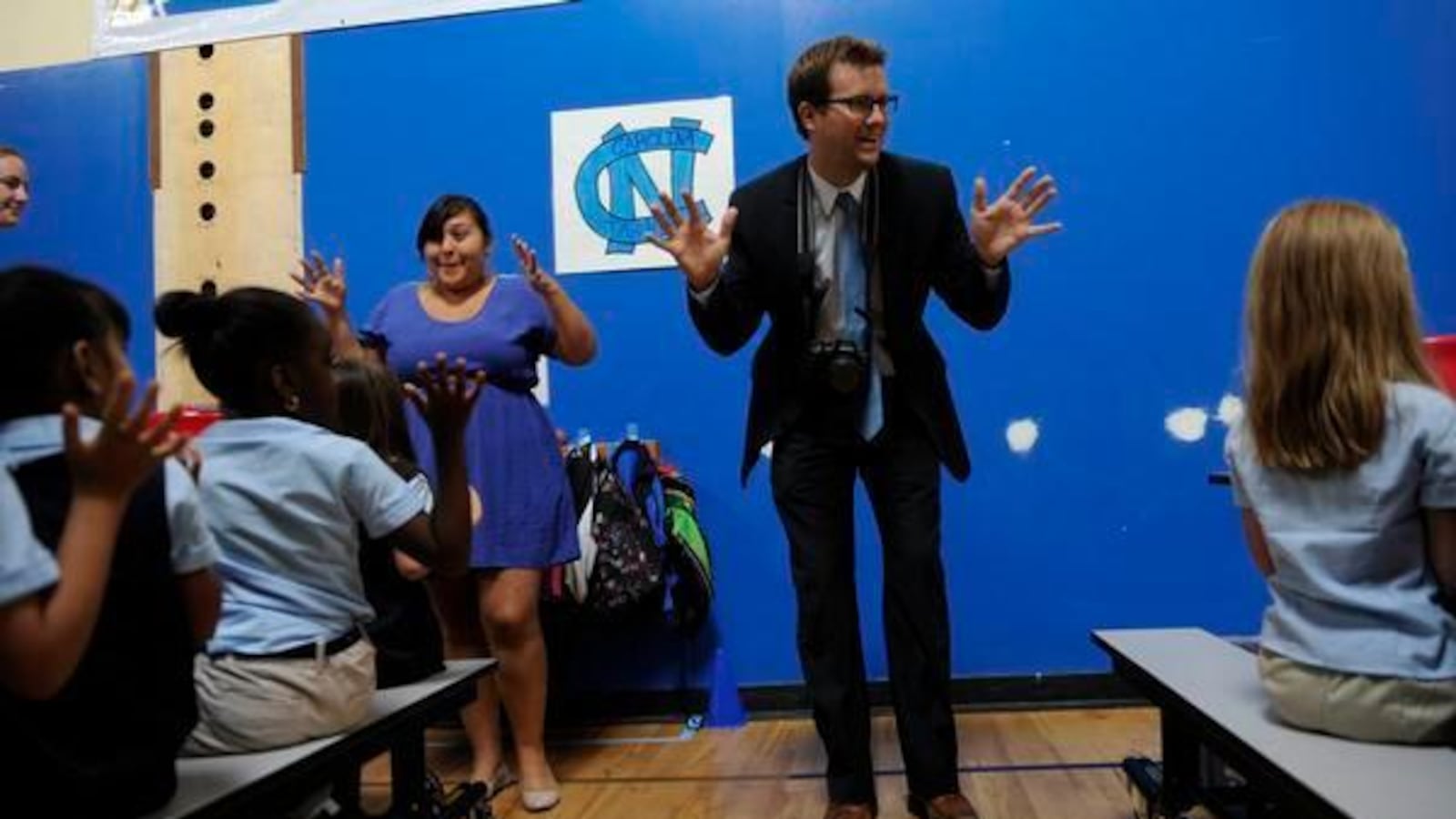 James Cryan, founder of Rocky Mountain Prep, leads students and staff in a cheer in 2012.