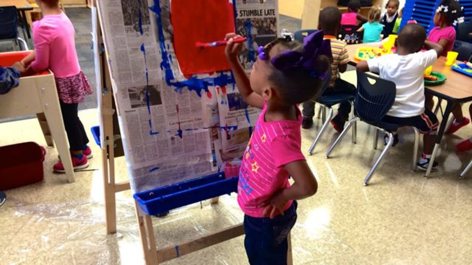 A preschooler at IPS School 102 paints a picture.