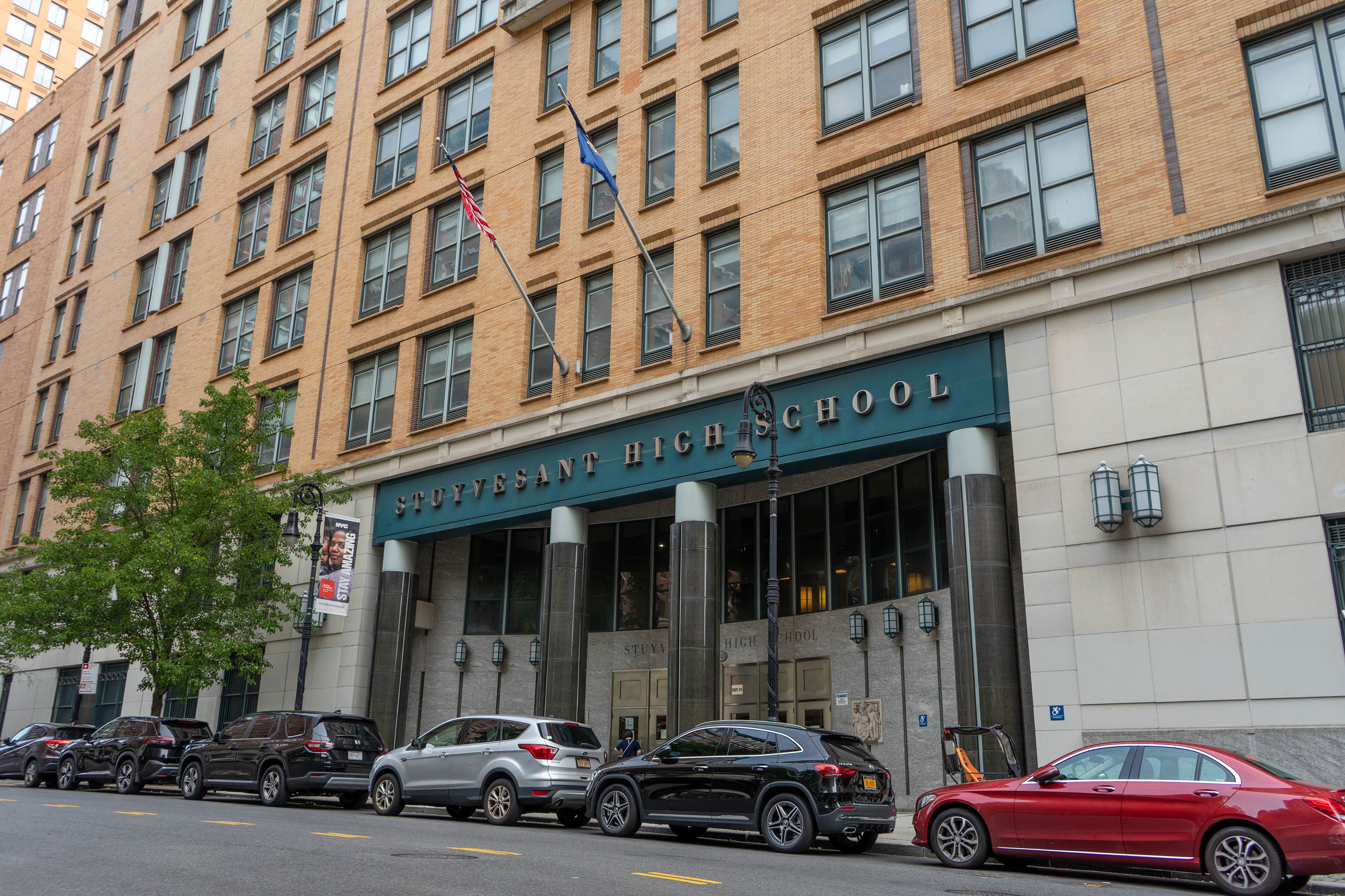 The entrance to a school building with giant words on the top that reads "Stuyvesant High School."