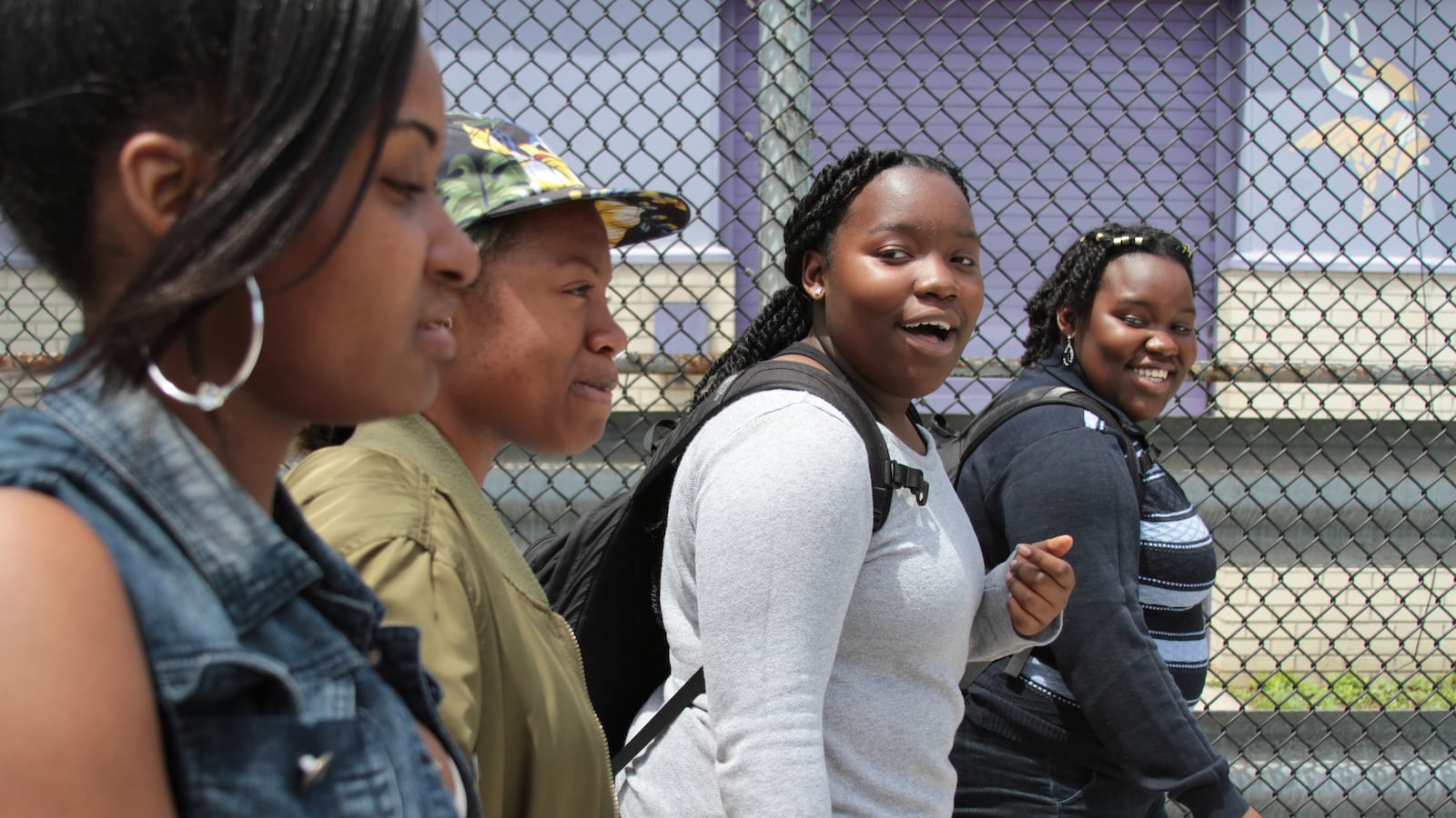 Ismaelle Oriental, 15, (center), and her twin-sister, Elodie, walk with friends after school.