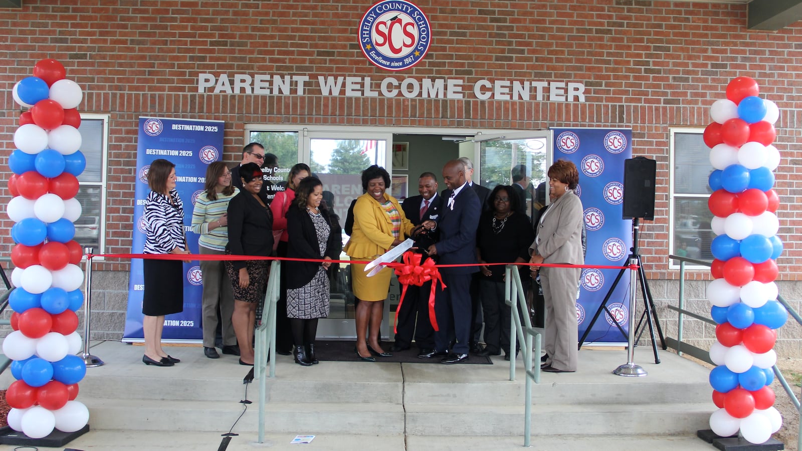 Surrounding by supporters, Superintendent Dorsey Hopson cuts the ribbon officially opening Shelby County Schools' new parent welcome center in Memphis.