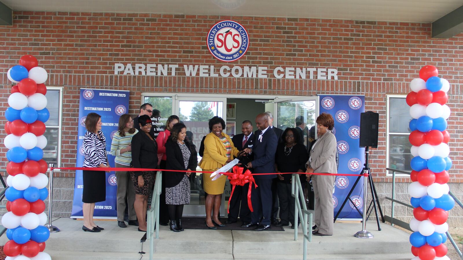 Surrounding by supporters, Superintendent Dorsey Hopson cuts the ribbon officially opening Shelby County Schools' new parent welcome center in Memphis.