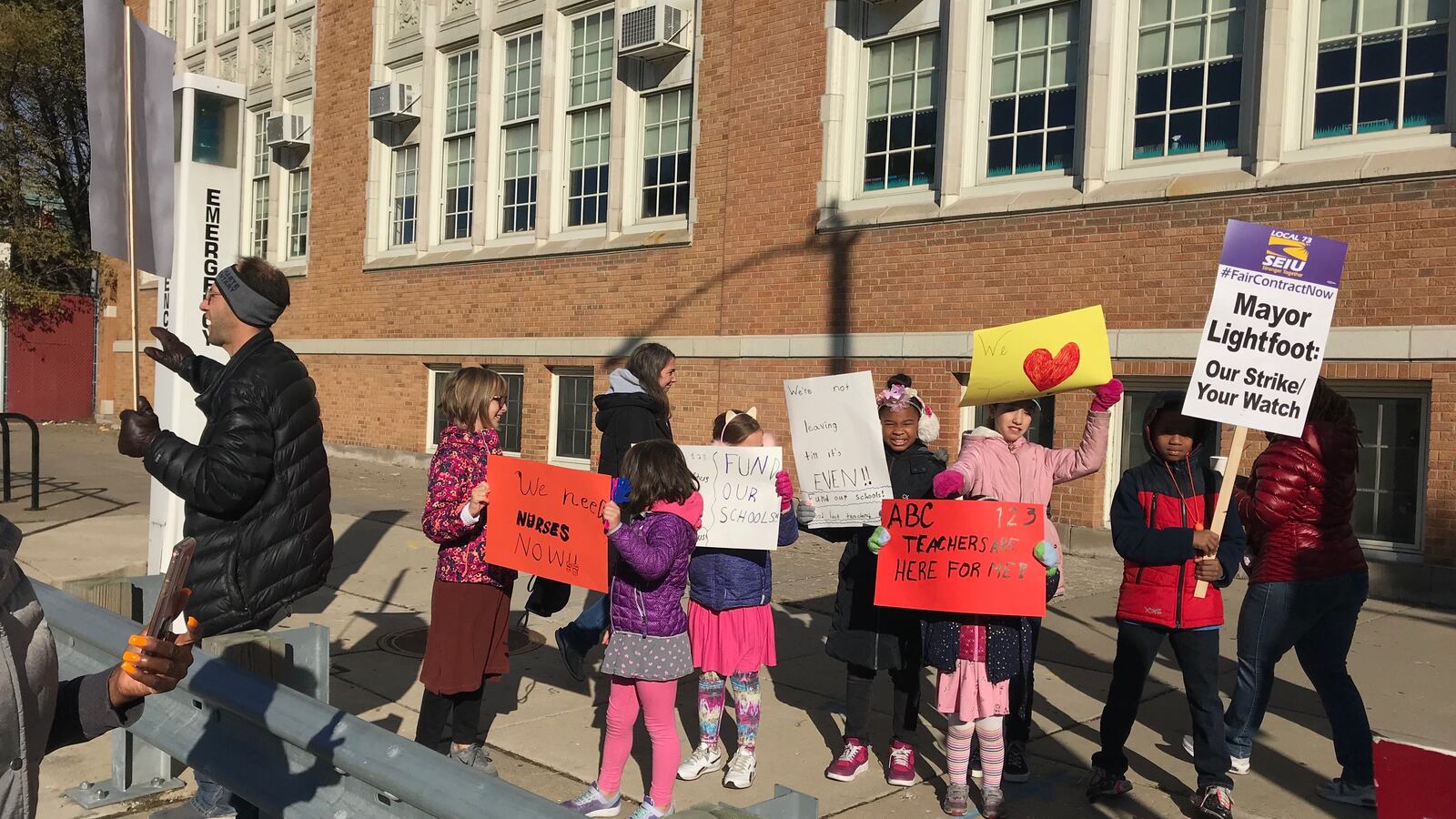 John Hieronymus and his two children joined the picket line at Bret Harte Elementary in Hyde Park on Oct. 17, 2019.