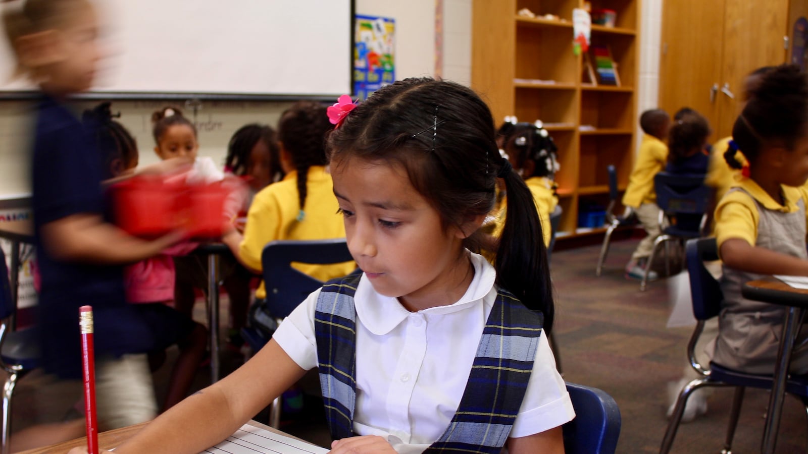 Zoe Roman, a kindergartener in Global Prep Academy's dual language program, fills in a writing worksheet.