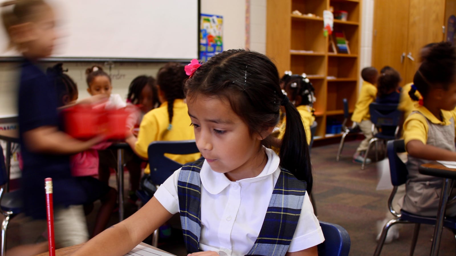 Zoe Roman, a kindergartener in Global Prep Academy's dual language program, fills in a writing worksheet.