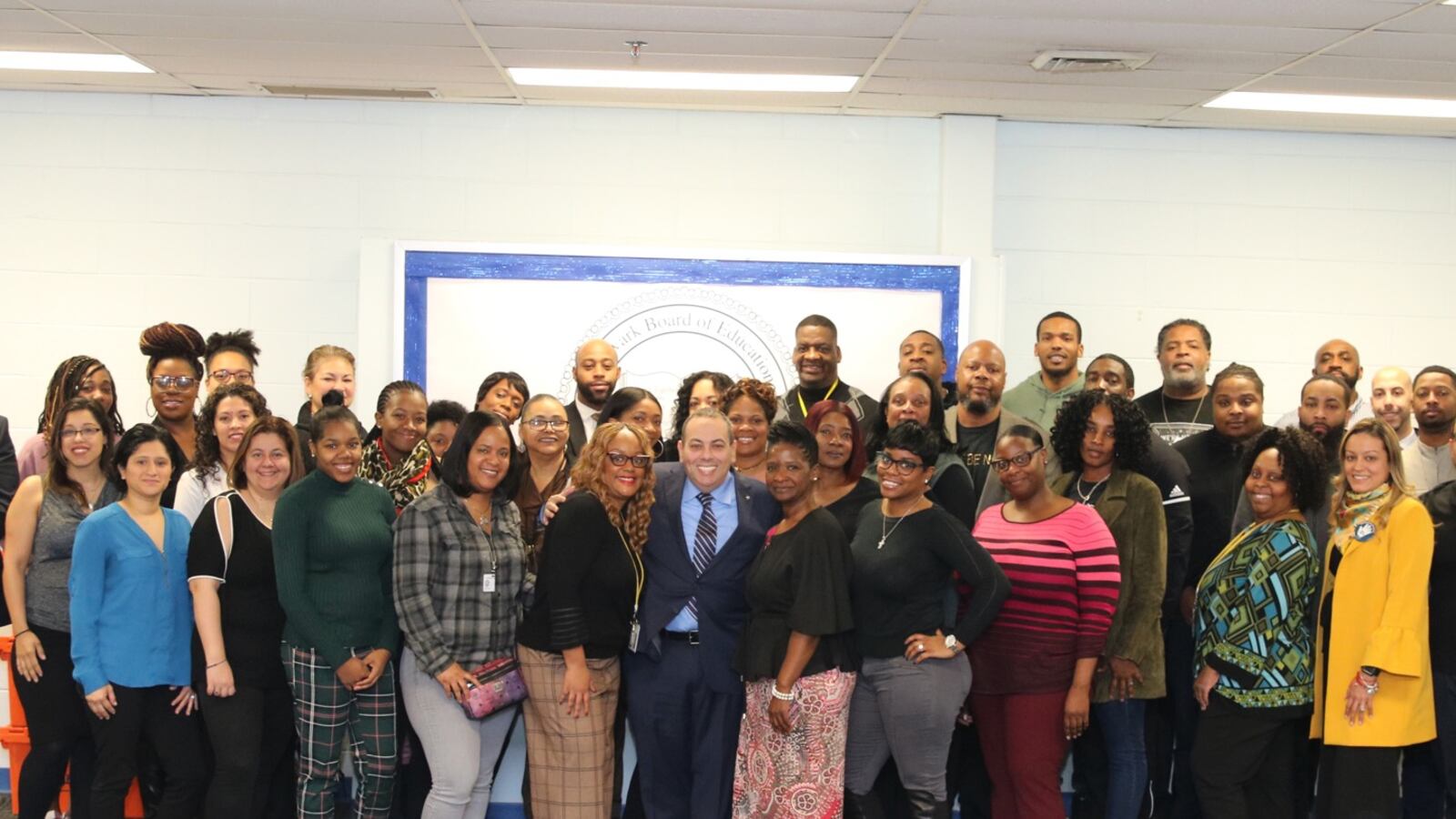 Superintendent Roger León (center) with more than 40 new attendance counselors the district has hired.